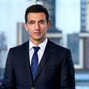 News reporter with city skyline backdrop.